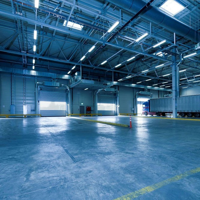 An expansive industrial warehouse facility showcasing Morristown Paving's commercial asphalt work in Morris County, NJ. It showcases smooth, durable indoor flooring suitable for the warehouse and show's the company's expertise.