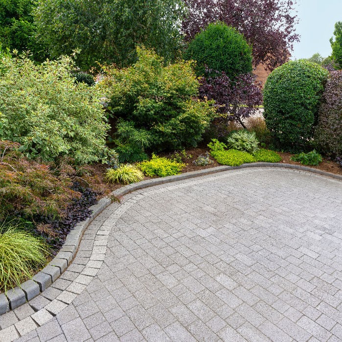 A paving project design in a backyard setting by Morristown Paving at a residence in Morris County, NJ. The project features concrete pavers laid in a neat decorative pattern, demonstrating the company's expertise.